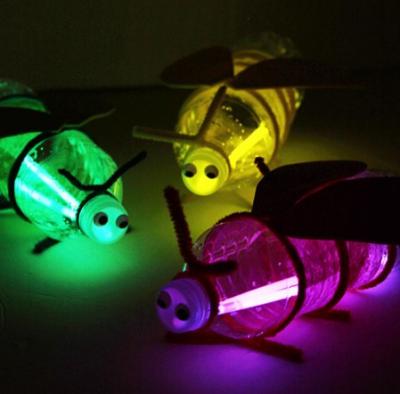 Glowing fire flies made from a pop bottle and glow sticks.